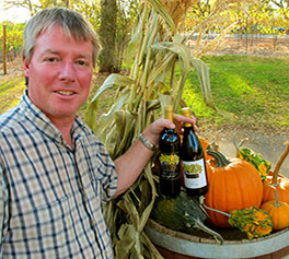 Winemaker Andrew Tanis with bottles of TANIS wine at harvest time 2012.